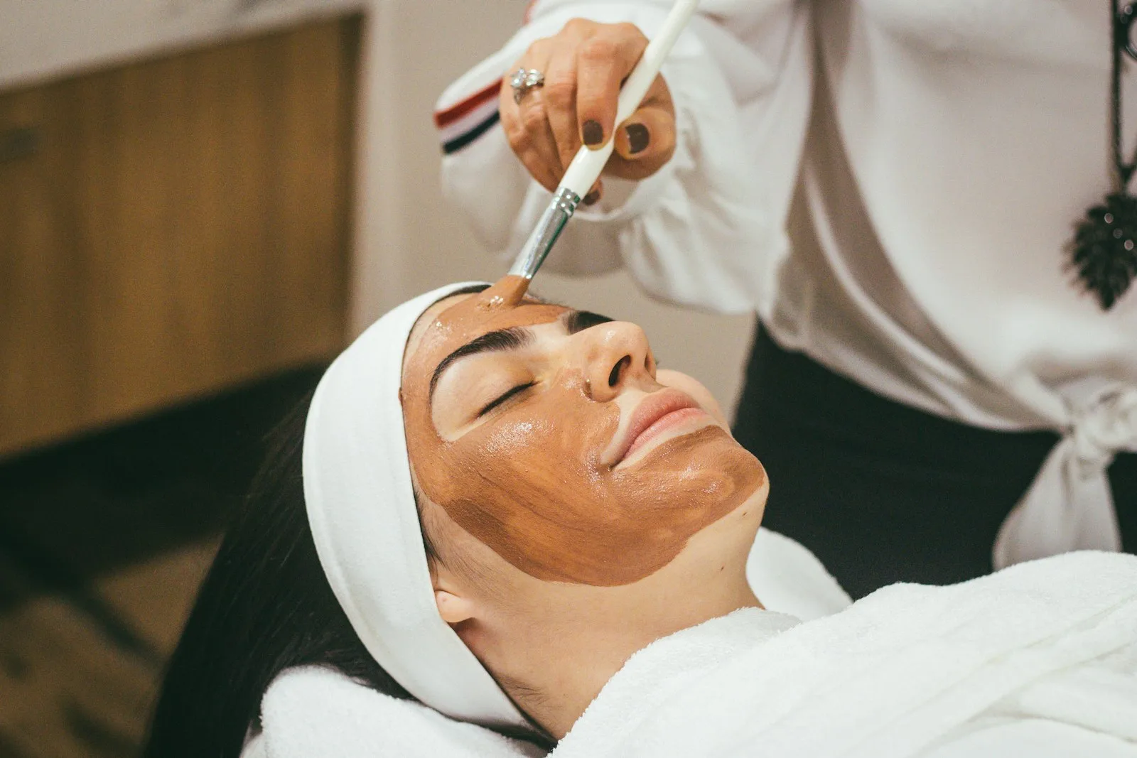 Woman receiving a HIFU facial lifting treatment at a Bangkok aesthetic clinic